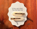 Pearl and gold hair clips on a bridesmaid proposal card
