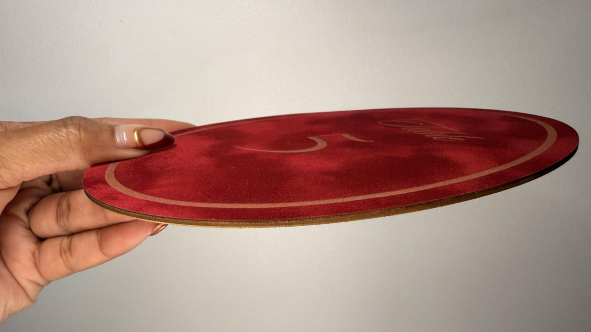 Oval velvet table number detail showing engraved velvet texture