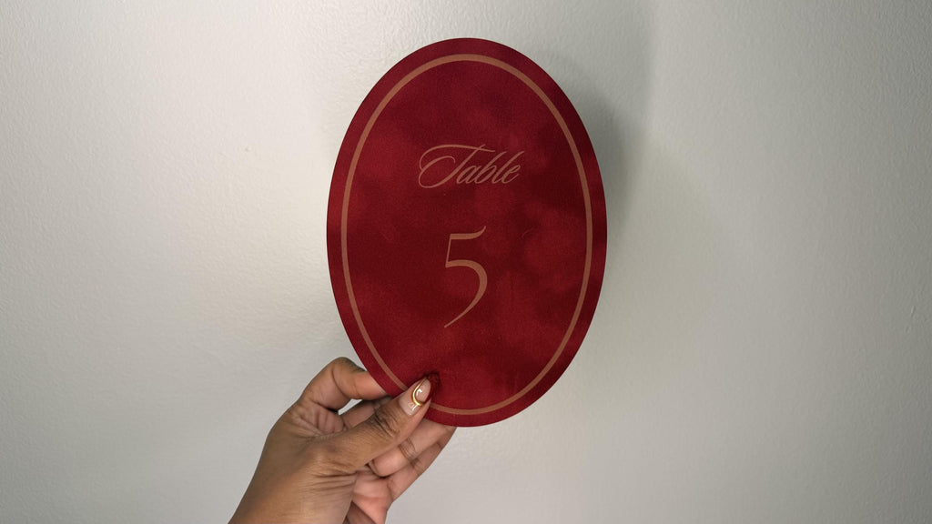 Oval velvet wedding table number with engraved numeral, wood backed